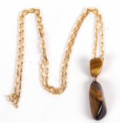 A 9ct tigers eye necklace, the double stone pendant with unmarked yellow metal mounts, 5.1cm long,