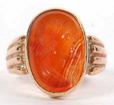 A late 19th century carnelian intaglio ring, the oval carnelian intaglio, 9.2mm long, collet mounted