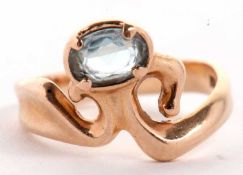 A contemporary 14k aquamarine ring, the oval faceted aquamarine, in a collet and claw mount, set