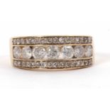 A 9ct diamond ring, the central channel set with round brilliant cut diamonds, set above and below