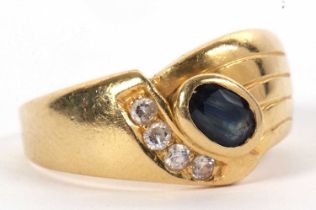 A sapphire and white stone ring, set with an oval collet mounted sapphire and four offset small