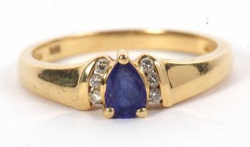 An 18k sapphire and diamond ring, the pear shaped sapphire set to ether side with diamond