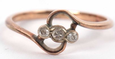 An 18ct three stone diamond ring, the three round old cut diamonds, set to centre of a crossover