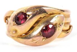 An early 20th century 9ct gemset snake ring, the two snake heads with a red gemstone set to each