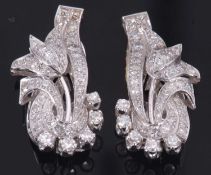 A pair of diamond earclips, the foliate styled earclips set throughtout with single cut diamonds,