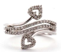 A 9ct white gold and diamond ring, the two strand style crossover ring with heart shaped