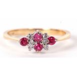 An 18ct pink sapphire and white stone ring, set with two small pink sapphires to centre with three