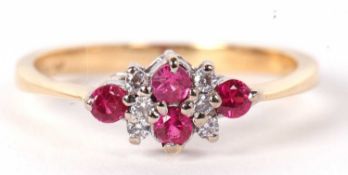 An 18ct pink sapphire and white stone ring, set with two small pink sapphires to centre with three