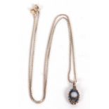 A silver pendant by Charles Horner, the oval silver pendant with blue enamel and faux moonstone,