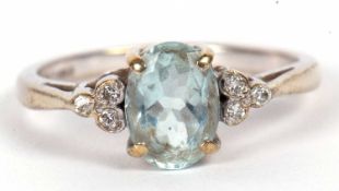 A 9ct white gold blue stone and diamond ring, the oval pale blue stone, possibly an aquamarine, claw