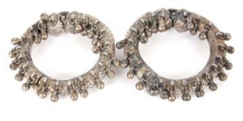 Two unmarked white metal Eastern style bracelets/ankle cuffs, the braod textured and patterned