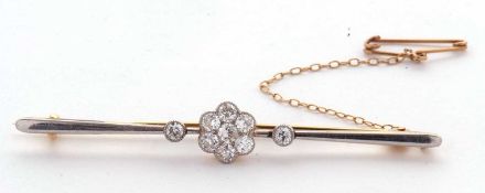 A diamond bar brooch, set to centre with a flowerhead cluster of old European cut diamonds and a