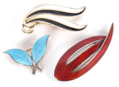 Three Scandanavian brooches: to include a silver and blue enamel leaf brooch by David Andersen,