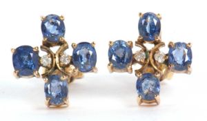A pair of tanzanite and diamond earrings, the four oval tanzanites set to centre with two small