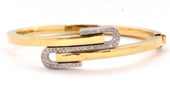 An 18ct diamond set hinged bangle, the 4mm wide crossover style bangle interspaced with a S-shape of