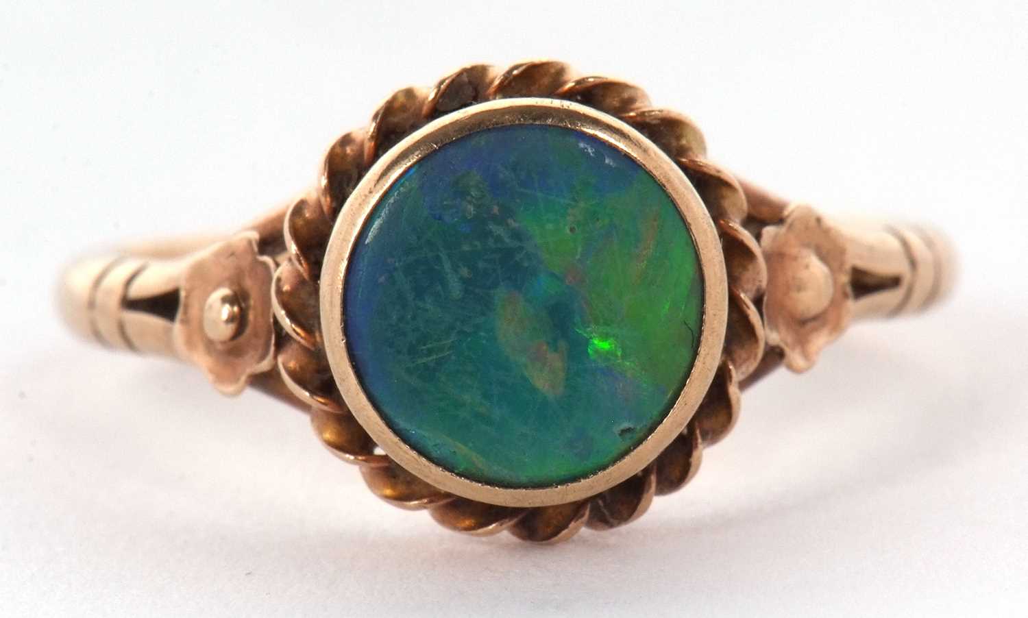 A 9ct opal ring,the round opal cabochon, collet mounted with rope twist border and closed back, 10. - Image 2 of 11