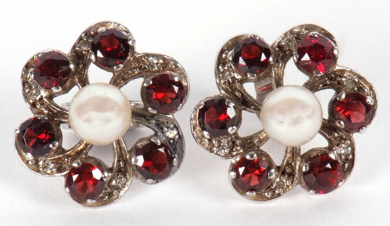 A pair of garnet, diamond and cultured pearl earrings, the central round cultured pearl surrounded