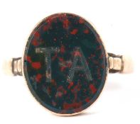 A bloodstone ring, the oval bloodstone panel with intials 'T.A. to front, collet mounted with closed