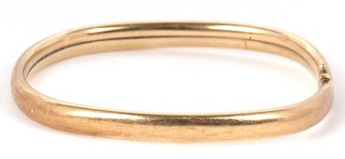 A 9ct bangle, the off-round bangle with integrated clasp, stamped 375 hallmarked Birmingham 1989,