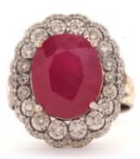 A 9ct ruby and diamond cluster ring, the central oval ruby, approx. 14 x 11.4 x 8.5mm, in a four