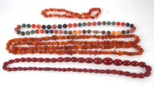 A 'cherry amber' bead necklace and two others, the 'cherry amber' beads between approx. 8 - 18mm,