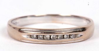 A 18ct diamond half hoop ring, set with a narrow channel of small round diamonds, with plain lower