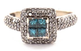 A blue and white diamond ring, the central four princess cut diamonds, surrounded by two rows of