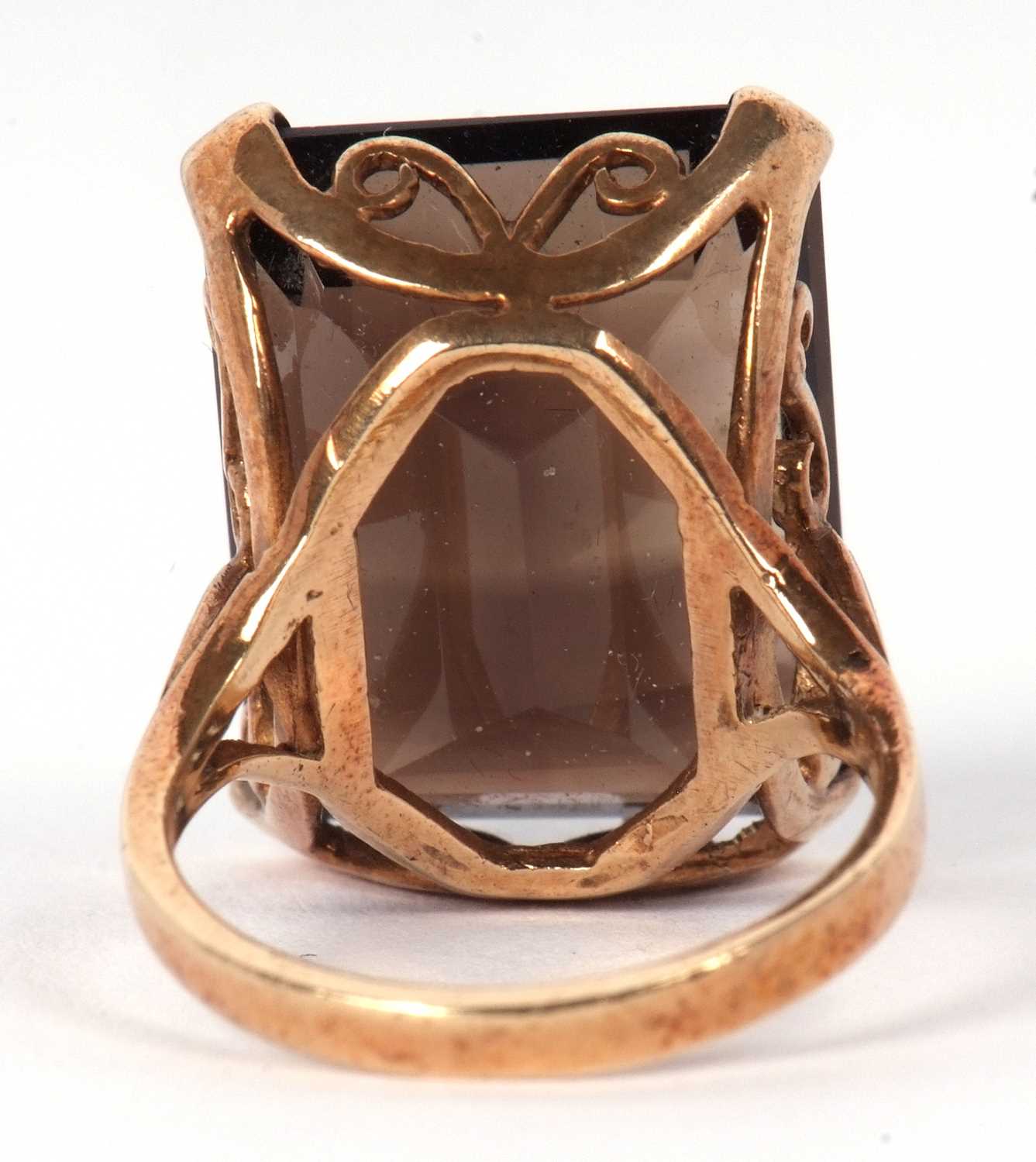 A 9ct smokey quartz ring, the emerald cut mokey quartz in a four claw mount and scrolled gallery, - Image 3 of 5