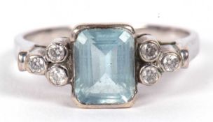 An aquamarine and diamond ring, the mixed cut rectangular emerald, collet mounted with three small