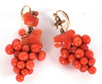 A pair of coral earrings, naturalistically modelled as a bunch of grapes with carved coral vine leaf