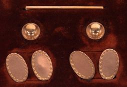 An early 20th cased gentleman's 9ct dress set, to include a pair of oval cufflinks, hallmarked