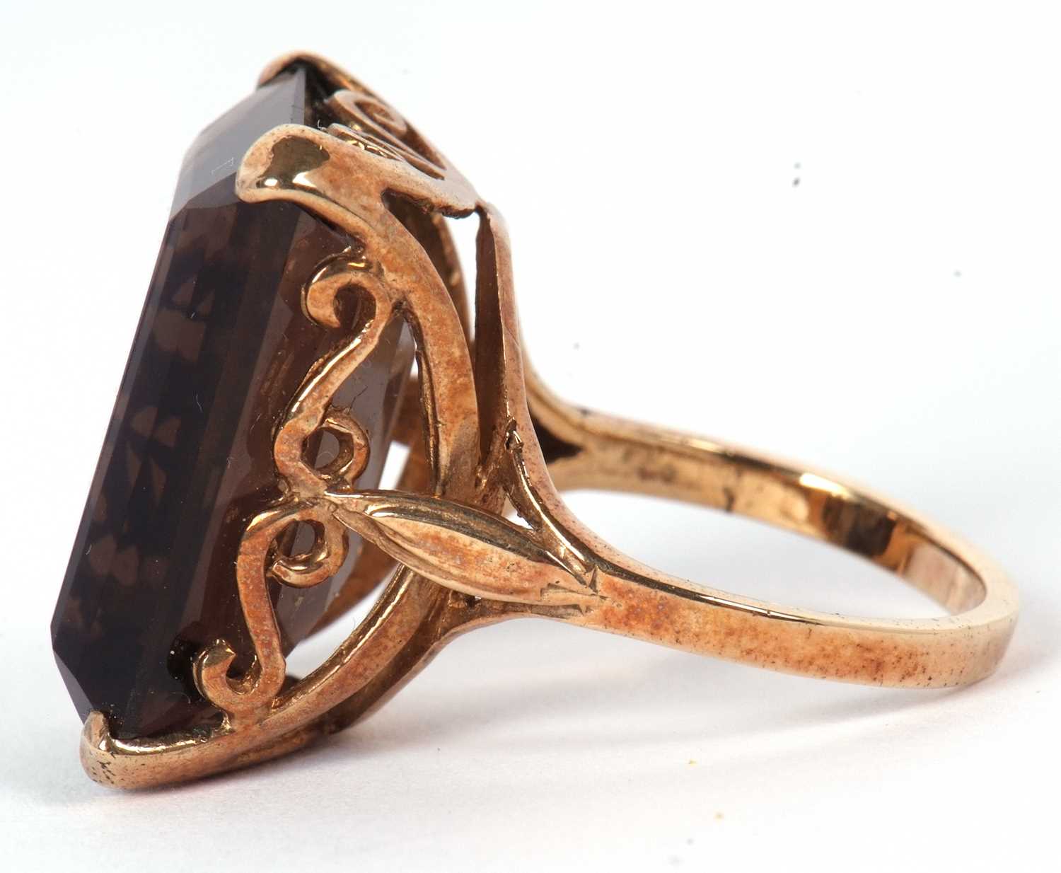 A 9ct smokey quartz ring, the emerald cut mokey quartz in a four claw mount and scrolled gallery, - Image 2 of 5