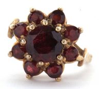 A 9ct garnet cluster ring, the flowerhead cluster set with round garnets, all claw mounted with