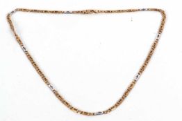 A 9ct two tone fancy link necklace, the yellow gold necklace with intermittenly spaced white gold