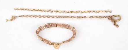 Three bracelets, to include a fancy link dolphin and floral link bracelet, one stamped 585, 18.5cm