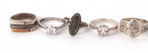 A group of silver rings, to include three CZ set rings, another with an oval white stone and a