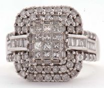 An 18ct white gold and diamond ring, the central panel set with princess cut diamonds, surrounded by