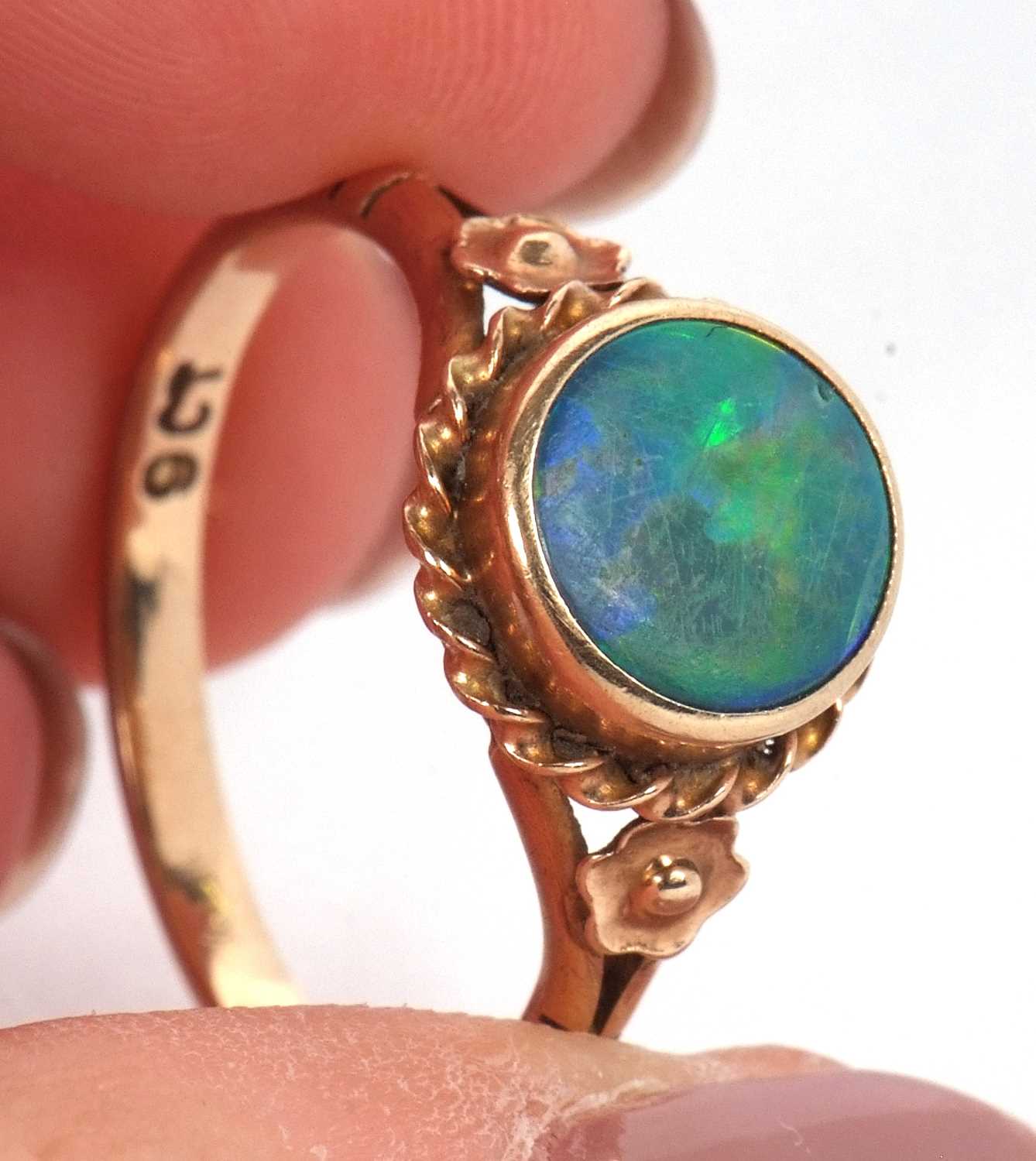 A 9ct opal ring,the round opal cabochon, collet mounted with rope twist border and closed back, 10. - Image 4 of 11