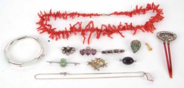 A mixed lot of jewellery to include a jade bangle with silver mounts, a coral branch necklace, paste