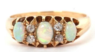 A late Victorian opal and diamond ring, the graduated oval opal cabochons, separated by two small