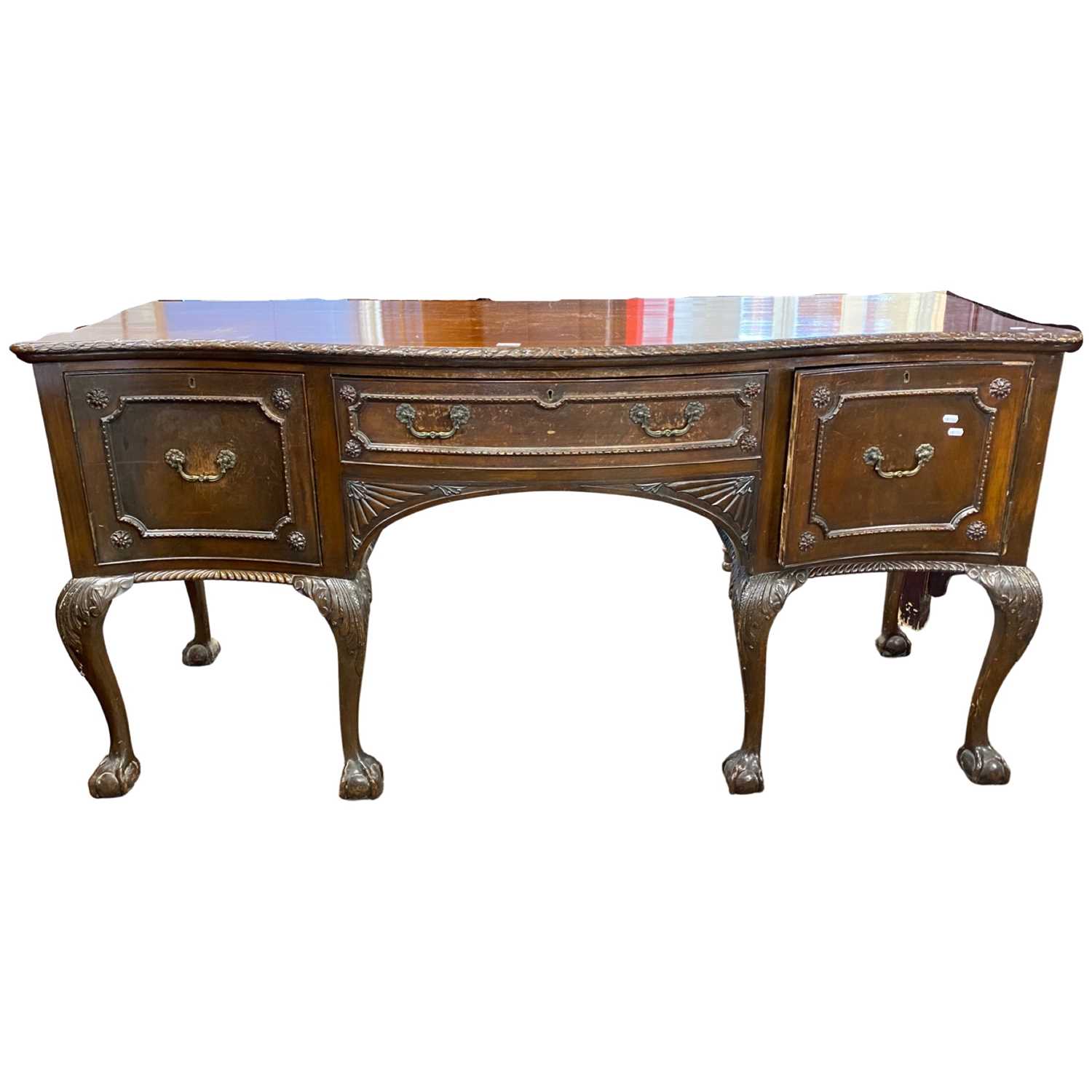 Large Georgian Revival mahogany sideboard of serpentine form with single drawer and two doors raised