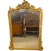 19th Century bevelled over mantel mirror set in an arched gilt finish frame with foliate mounts,