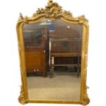 19th Century bevelled over mantel mirror set in an arched gilt finish frame with foliate mounts,