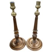 A pair of turned oak candlesticks with metal sconces, 38cm high