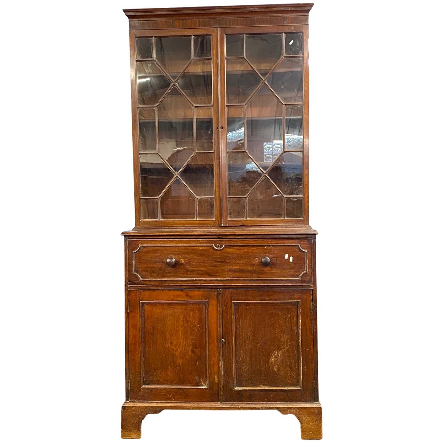A Georgian mahogany secretaire bookcase cabinet with glazed top section over a base with