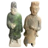 Pair of Chinese, probably Ming Dynasty attendant pottery figures, one with green glazed coat, 25cm