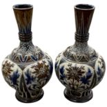 A pair of Doulton vases with incised floral designs, 20cm high