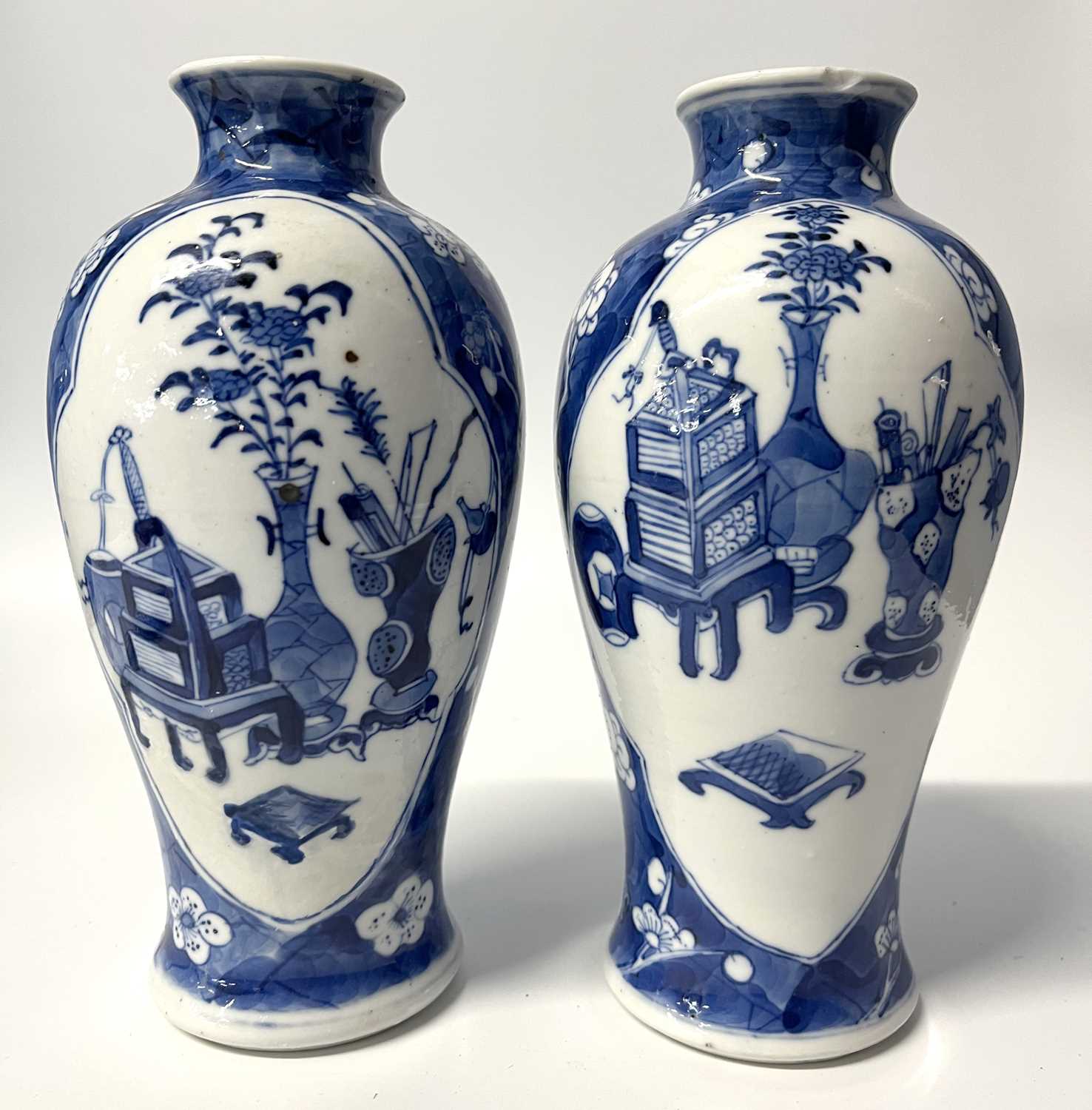 A pair of small Chinese porcelain vases in Qing Shi style with panels decorated with precious