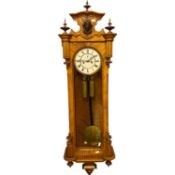 A 19th Century Vienna wall clock with brass twin weight movement and a white enamel dial (