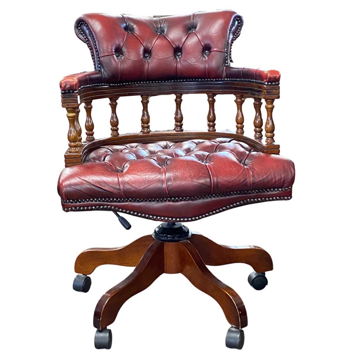 A 20th Century red leather upholstered revolving Captains style office chair, 65cm wide